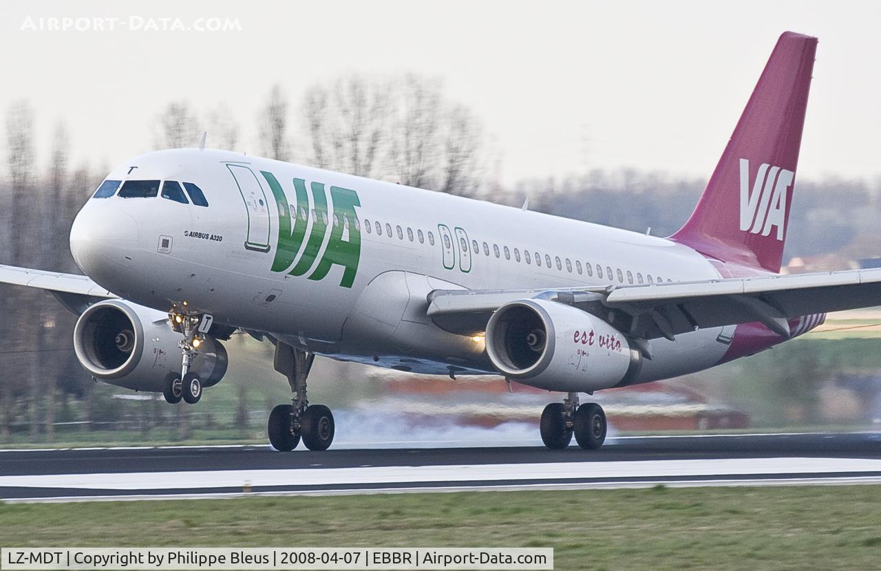 LZ-MDT, 2004 Airbus A320-232 C/N 2108, Burning rubber at landing; bouncing on rwy 25L at sunset.