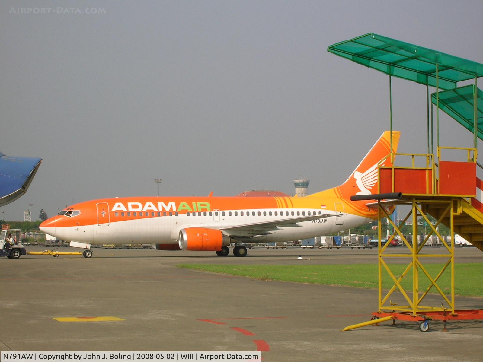 N791AW, 1990 Boeing 737-33A C/N 24791, Under tow at Jakarta prior to ferry to Kuala Lumpur by John Boling and Jack Nelson