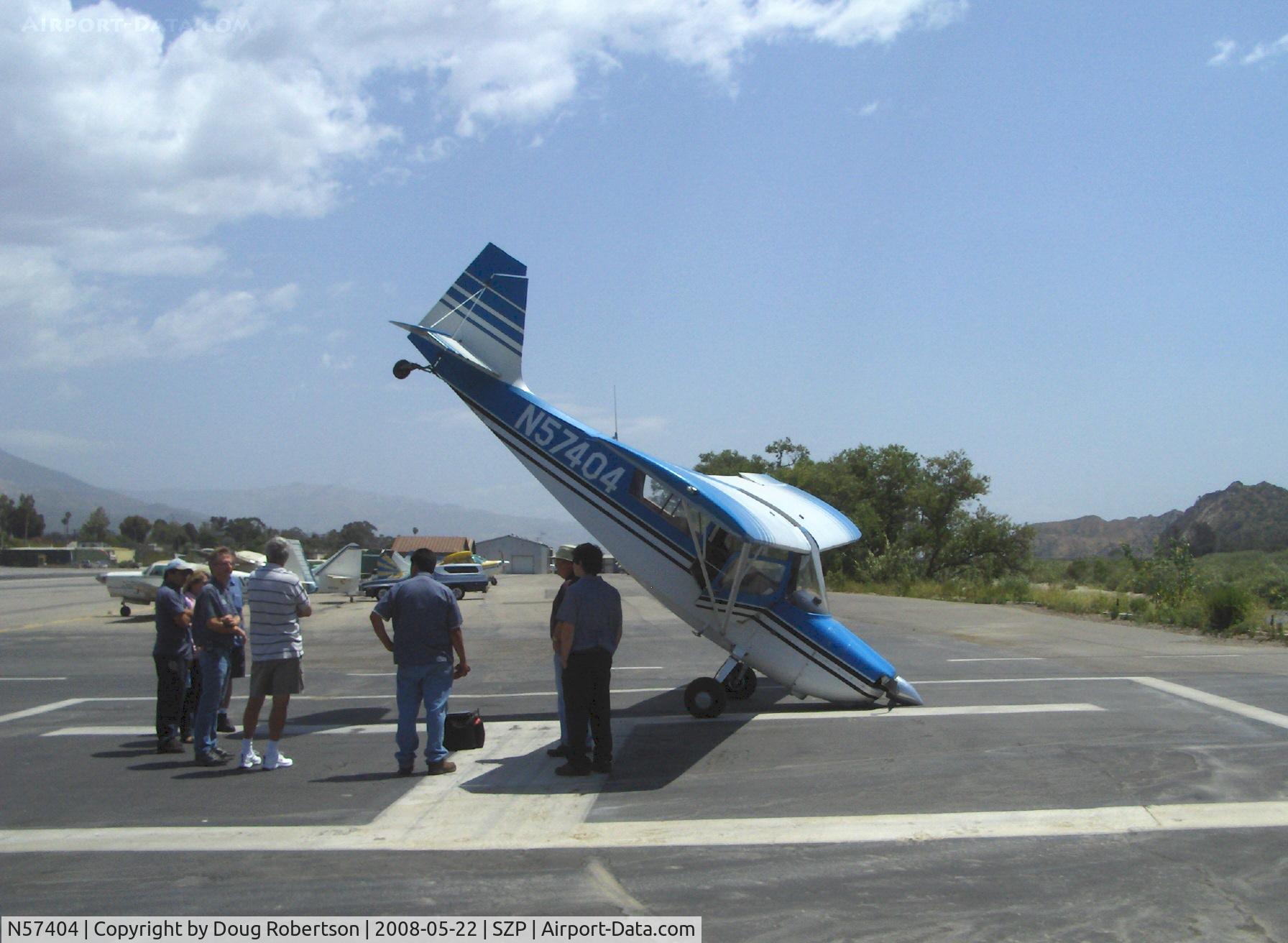 N57404, 1973 Bellanca 7ECA Citabria C/N 940-73, 1973 Bellanca 7ECA CITABRIA, Lycoming O-235 115 Hp, strong gusting left crosswind weathervaned aircraft off Rwy 22 on landing roll. Solo pilot stopped aircraft on SZP's helipad about 30 feet short of going over bank into Santa Clara River.
