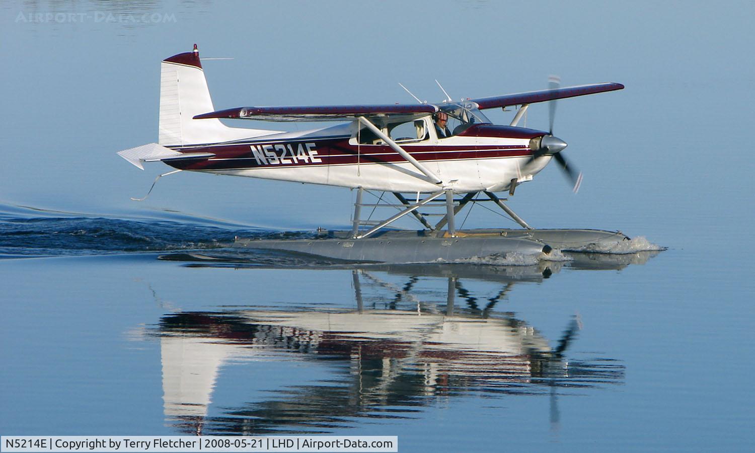 N5214E, 1959 Cessna 180B C/N 50514, A beautiful mirror image as this Cessna 180B makes an early morning departure from Lake Hood