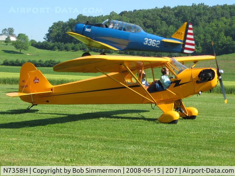 N7358H, 1946 Piper J3C-65 Cub Cub C/N 20617, Right place at the right time.  N7358H taxiing out to depart Beach City fly-in with N3362 taking off in the background.