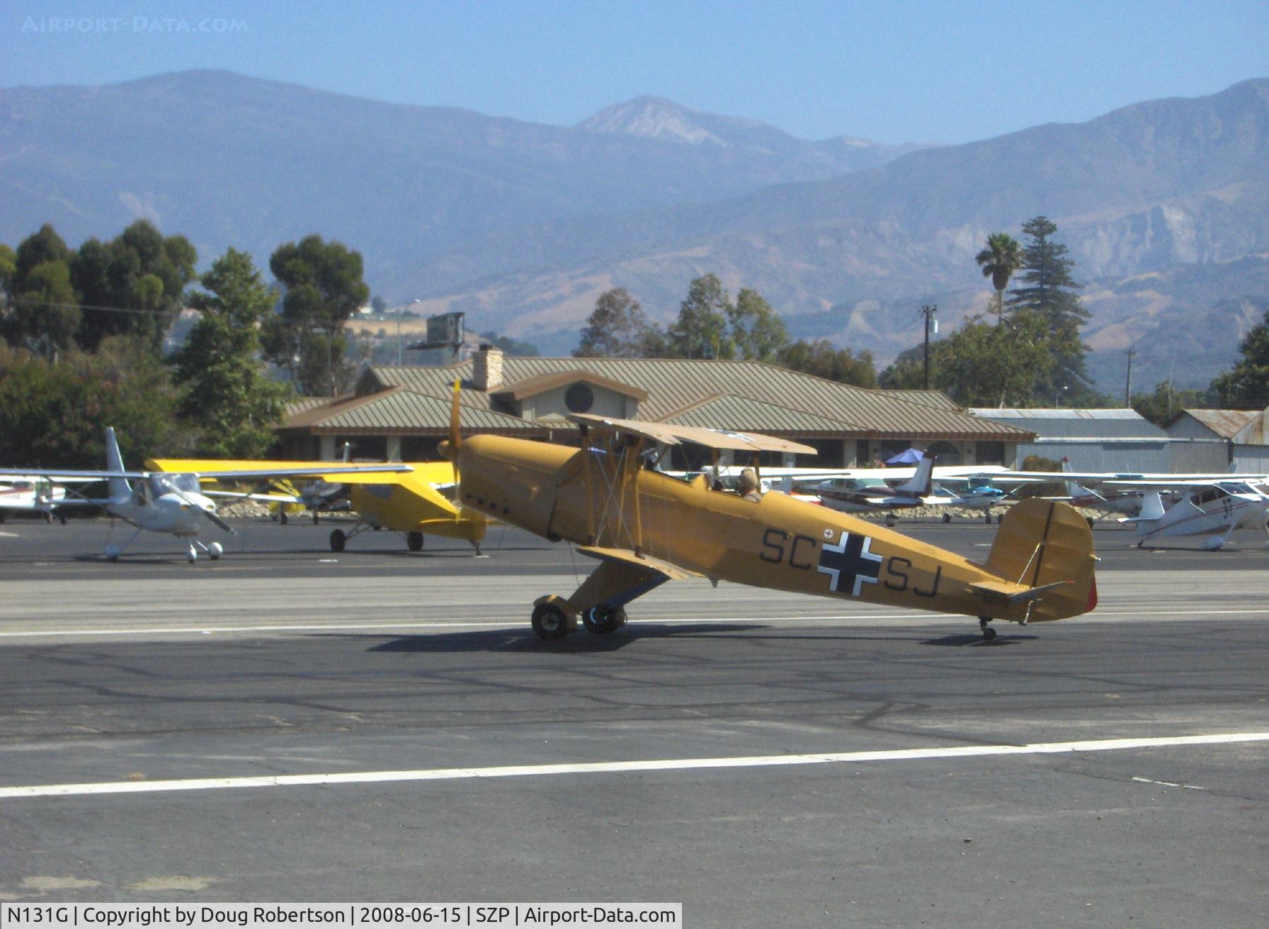 N131G, 1959 CASA 1-131 Jungmann C/N E3B-391, 1959 C.A.S.A. 1.131 Bucker JUNGMANN, taxi across Rwy 22. listed as having a Lycoming O&VO-180 but looks and sounds like an original inverted in-line engine-which in fact is a LOM 332AK of 140 Hp