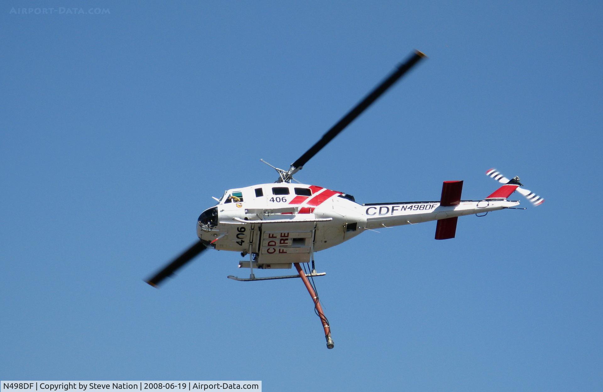 N498DF, Bell UH-1H C/N 69-15865, CDF Bell UH-1H Helitak 406 working fire off of State Hwy 68 ~ 4 miles NE of Monterey, CA