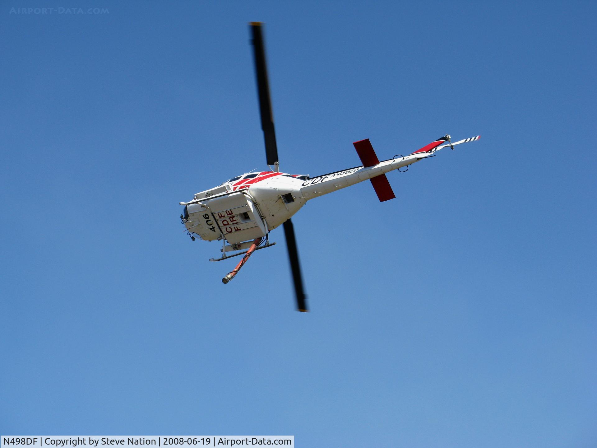 N498DF, Bell UH-1H C/N 69-15865, CDF Bell UH-1H Helitak 406 working fire off of State Hwy 68 ~ 4 miles NE of Monterey, CA