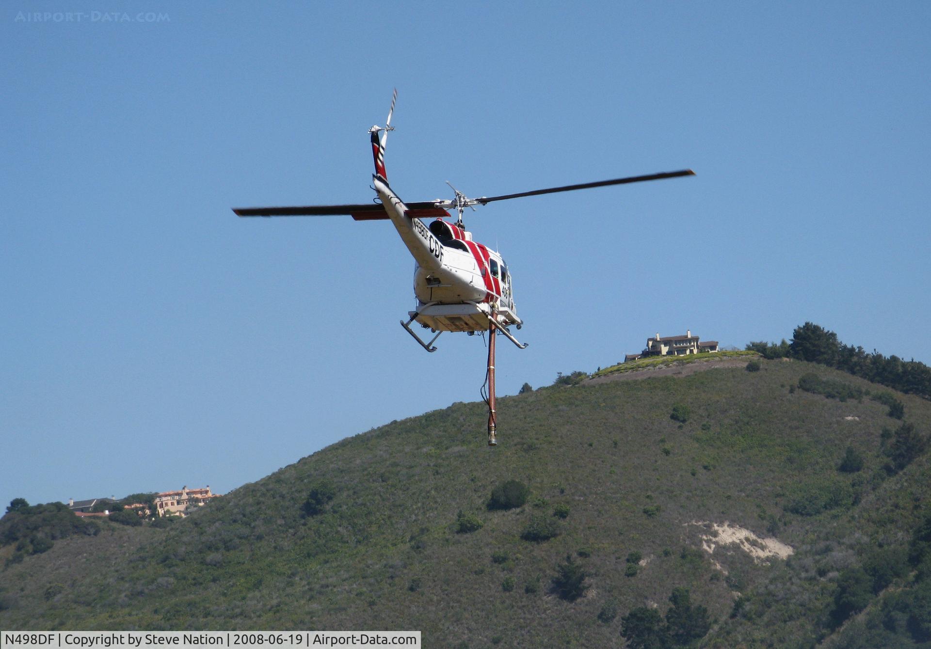 N498DF, Bell UH-1H C/N 69-15865, CDF Bell UH-1H Helitak 406 working fire off of State Hwy 68 ~ 4 miles NE of Monterey, CA