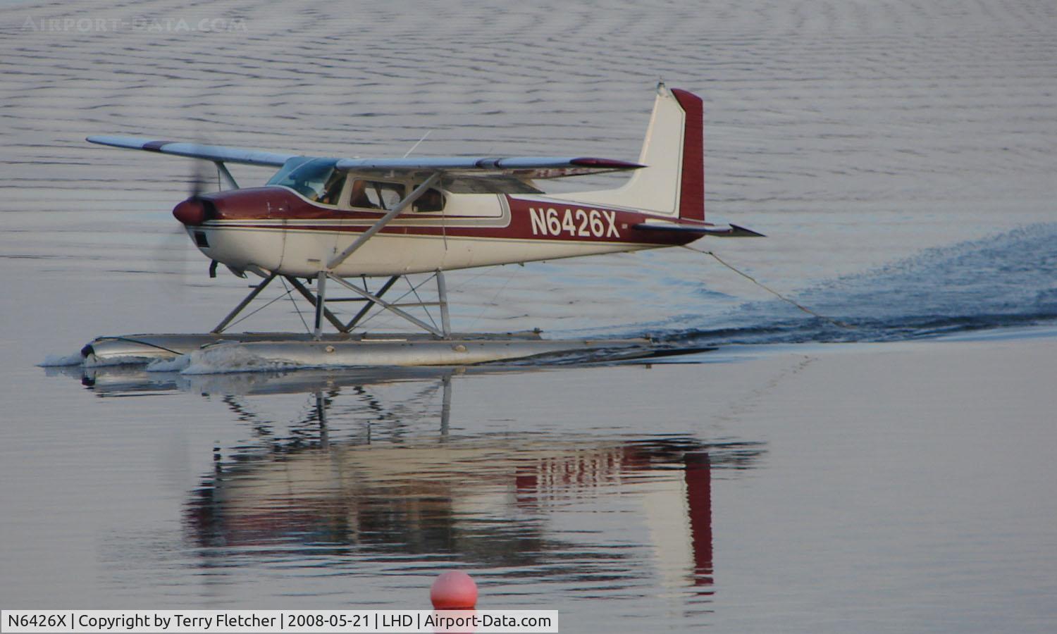 N6426X, 1960 Cessna 180D C/N 18050926, Cessna 180D forms a mirror image on Lake Hood