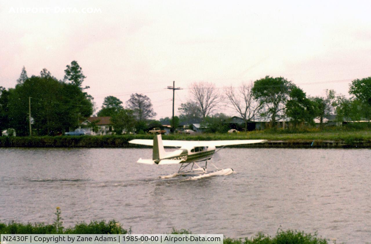 N2430F, 1965 Cessna 180H Skywagon C/N 18051630, Taking off in Bayou Lafourche Cut Off, LA