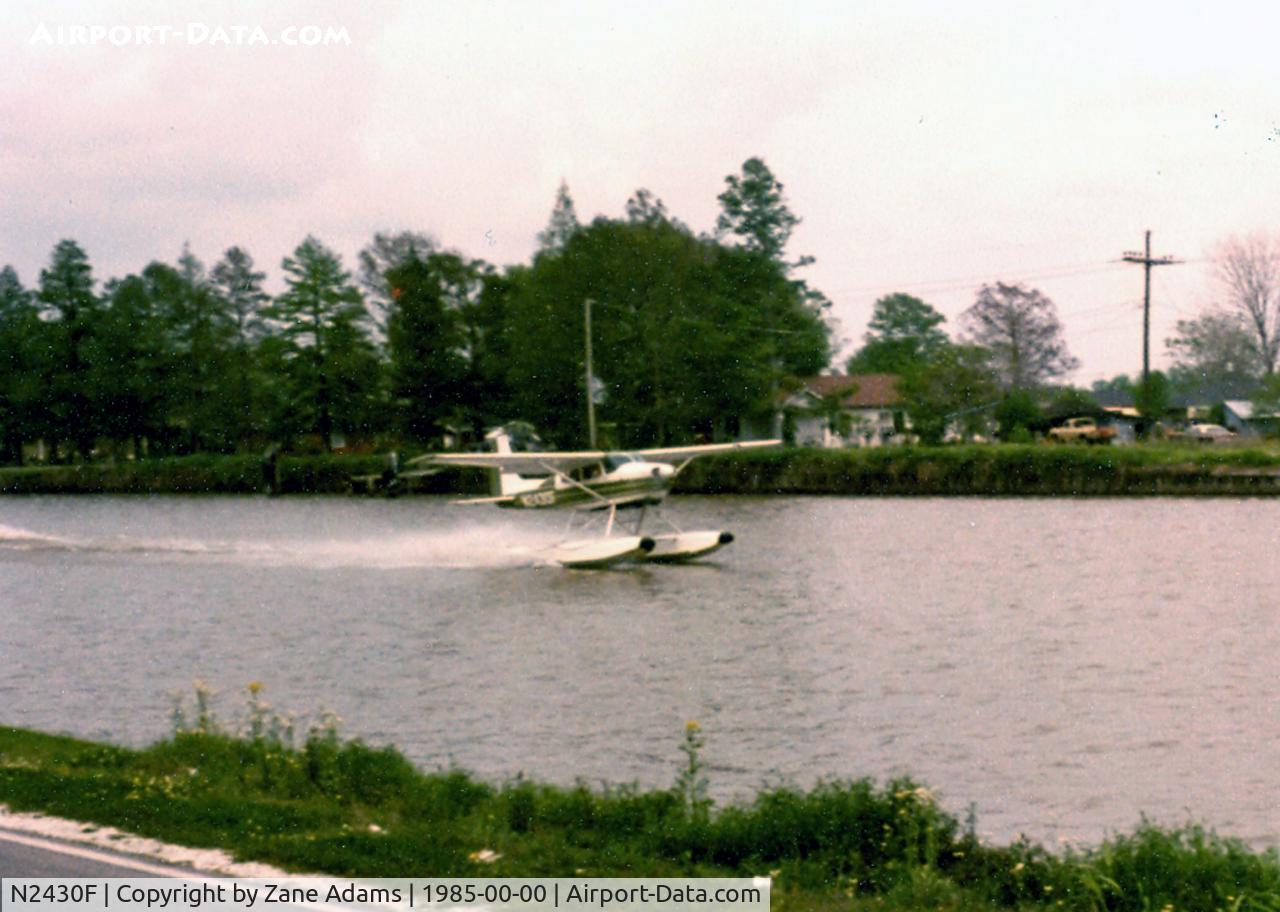 N2430F, 1965 Cessna 180H Skywagon C/N 18051630, Taking off in Bayou Lafourche Cut Off, LA