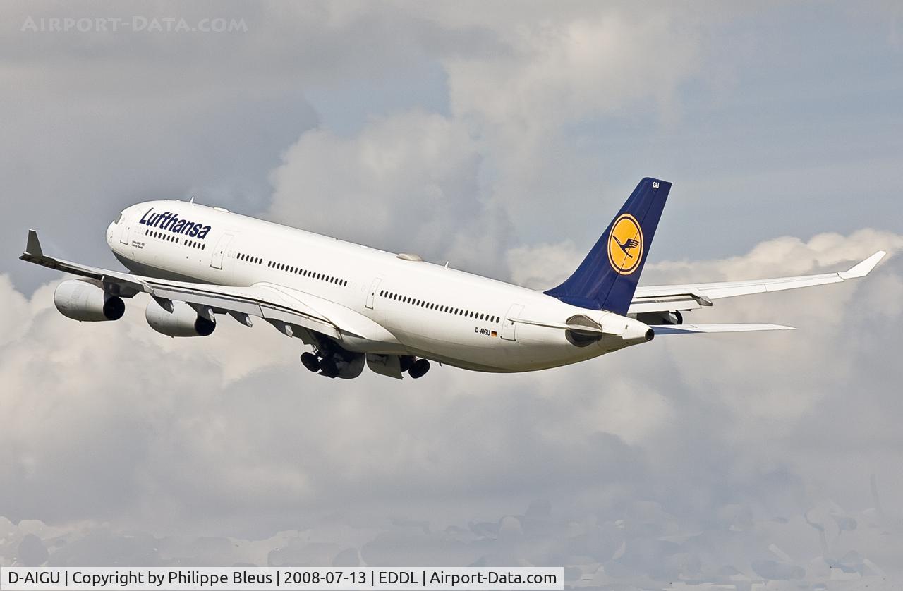 D-AIGU, 2000 Airbus A340-313 C/N 321, Climbing from rwy 23L through impressive clouds. Main gear on the move.