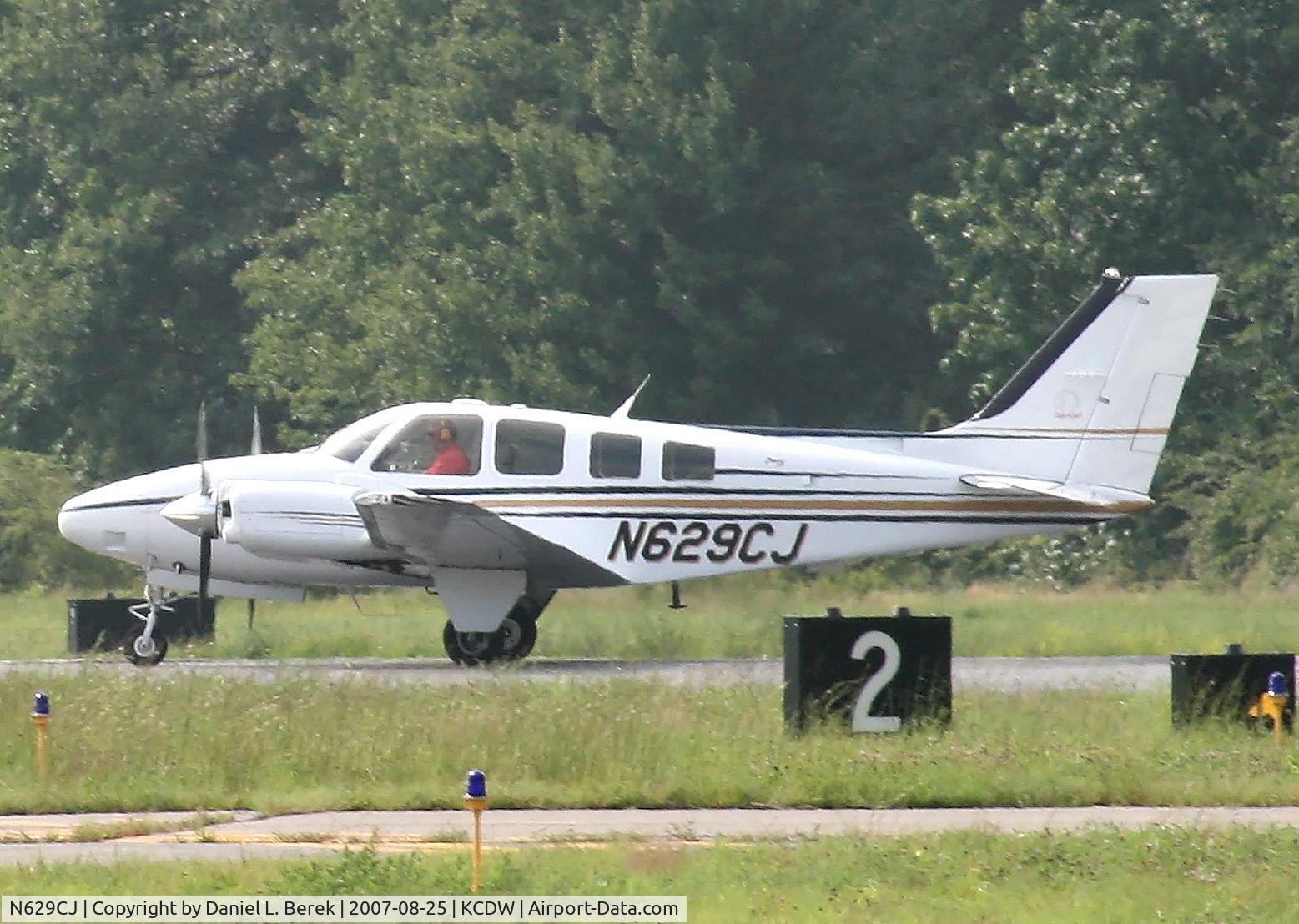 N629CJ, Raytheon Aircraft Company 58 C/N TH-2104, Gleaming Baron touches down at Caldwell.