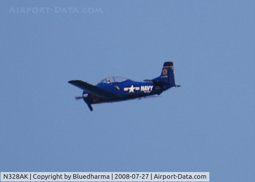 N328AK, 1956 North American T-28C Trojan C/N 226-32 (140455), Flying over West Littleton by Columbine Highschool in Littleton Colorado. USS Kittyhawk on tail.