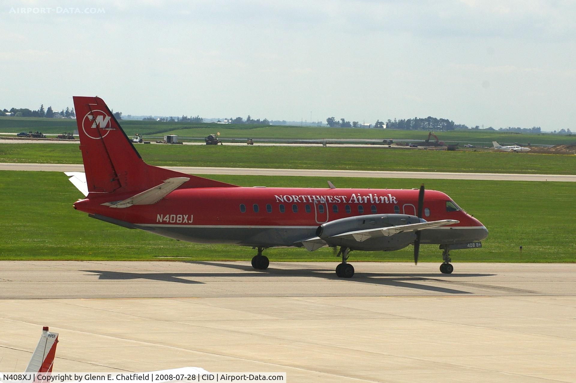 N408XJ, 1996 Saab 340B C/N 340B-408, Taxiing to Runway 13 for departure.  Seen from second floor window of the control tower.