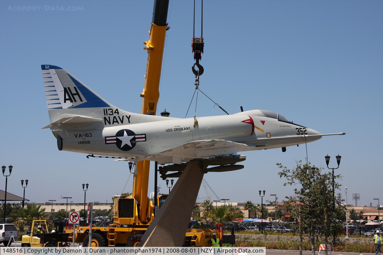 148516, Douglas A-4C Skyhawk C/N 12709, A-4C Skyhawk being welded to stand at North Island Naval Air Station as gate guard