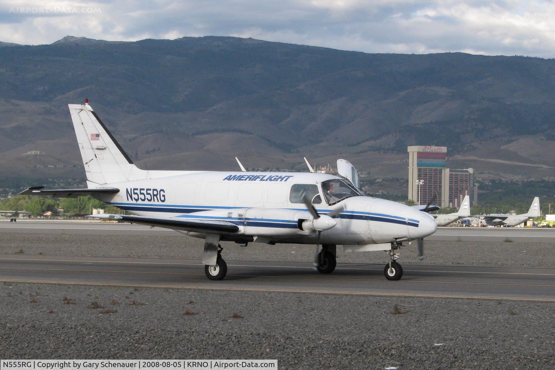 N555RG, 1973 Piper PA-31-350 Chieftain C/N 31-7305103, The pilot of this Ameriflight Piper gives a wave as he rolls down taxiway Charlie for an early morning takeoff from runway 16L.