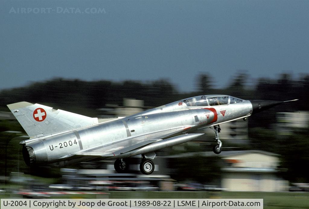 U-2004, Dassault Mirage IIIBS C/N Not found U-2004, In 1989 a few silver Mirages were still flying. This IIIBS trainer was one of those. This aircraft was later converted to Mirage IIIDS standards and reserialled J-2004.