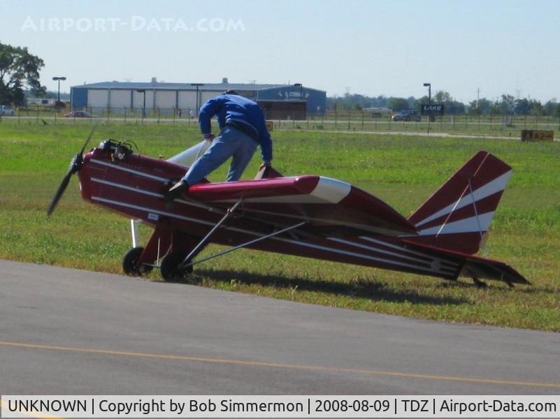 UNKNOWN, , After starting the Rotax engine with a pull rope, the pilot boards the aircraft over the front of the wing.  EAA breakfast fly-in at Toledo, OH.