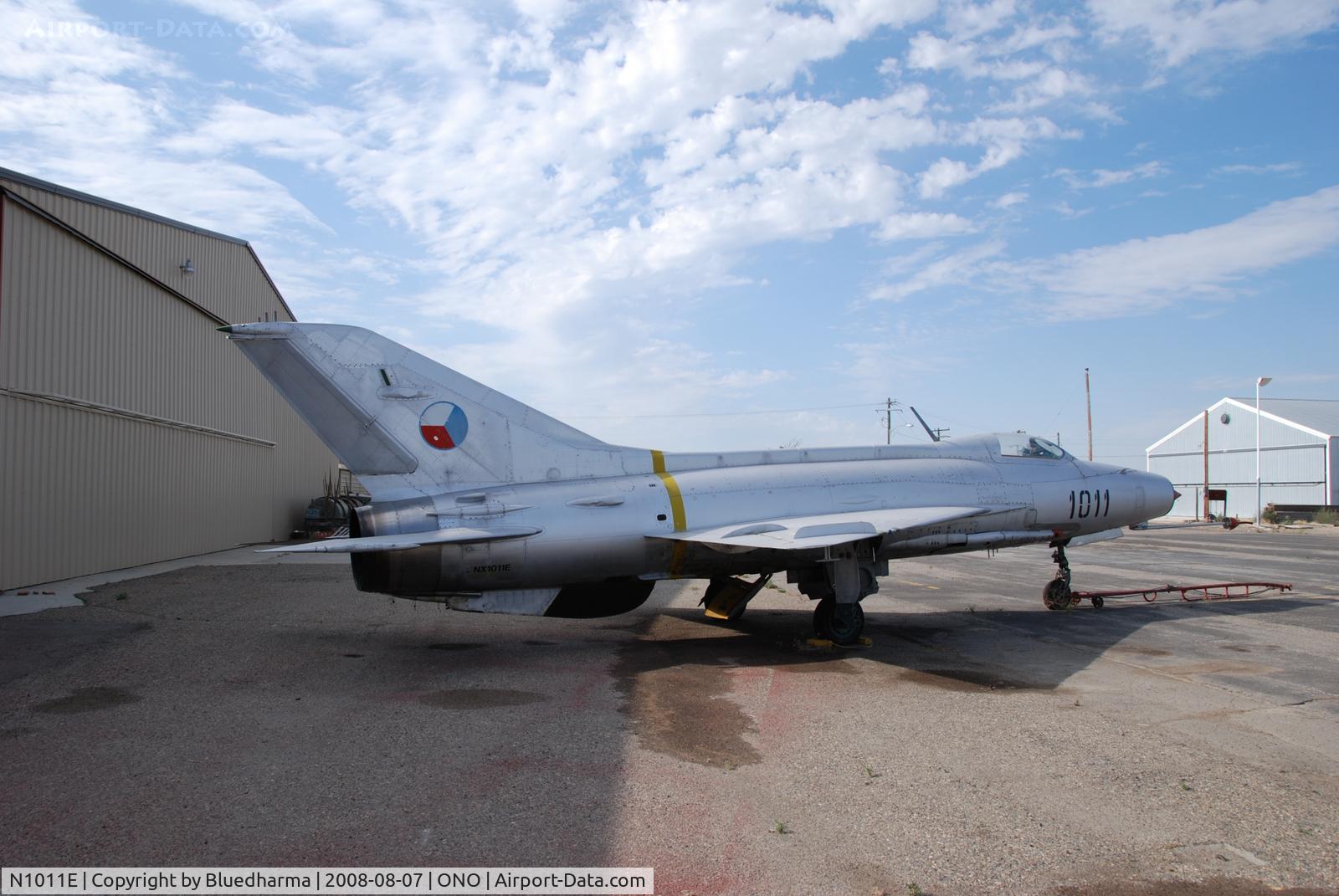 N1011E, Mikoyan-Gurevich MiG-21F-13 C/N 1011, Parked by hanger at airport.