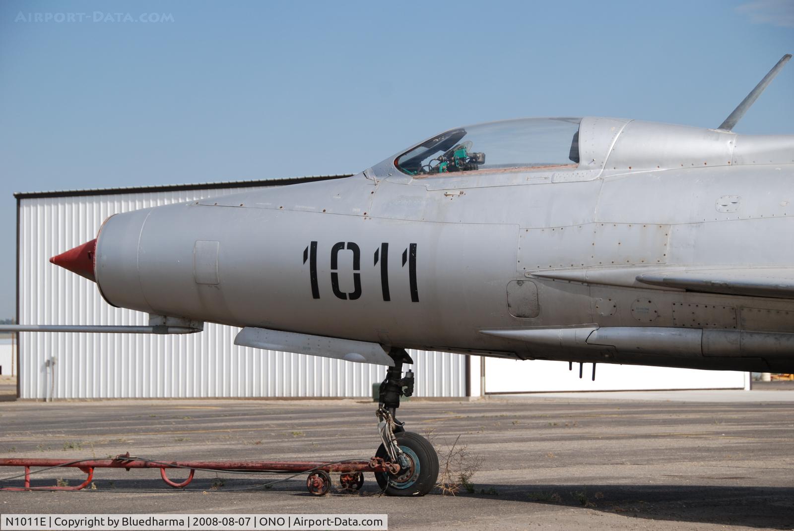 N1011E, Mikoyan-Gurevich MiG-21F-13 C/N 1011, Parked by hanger at airport.