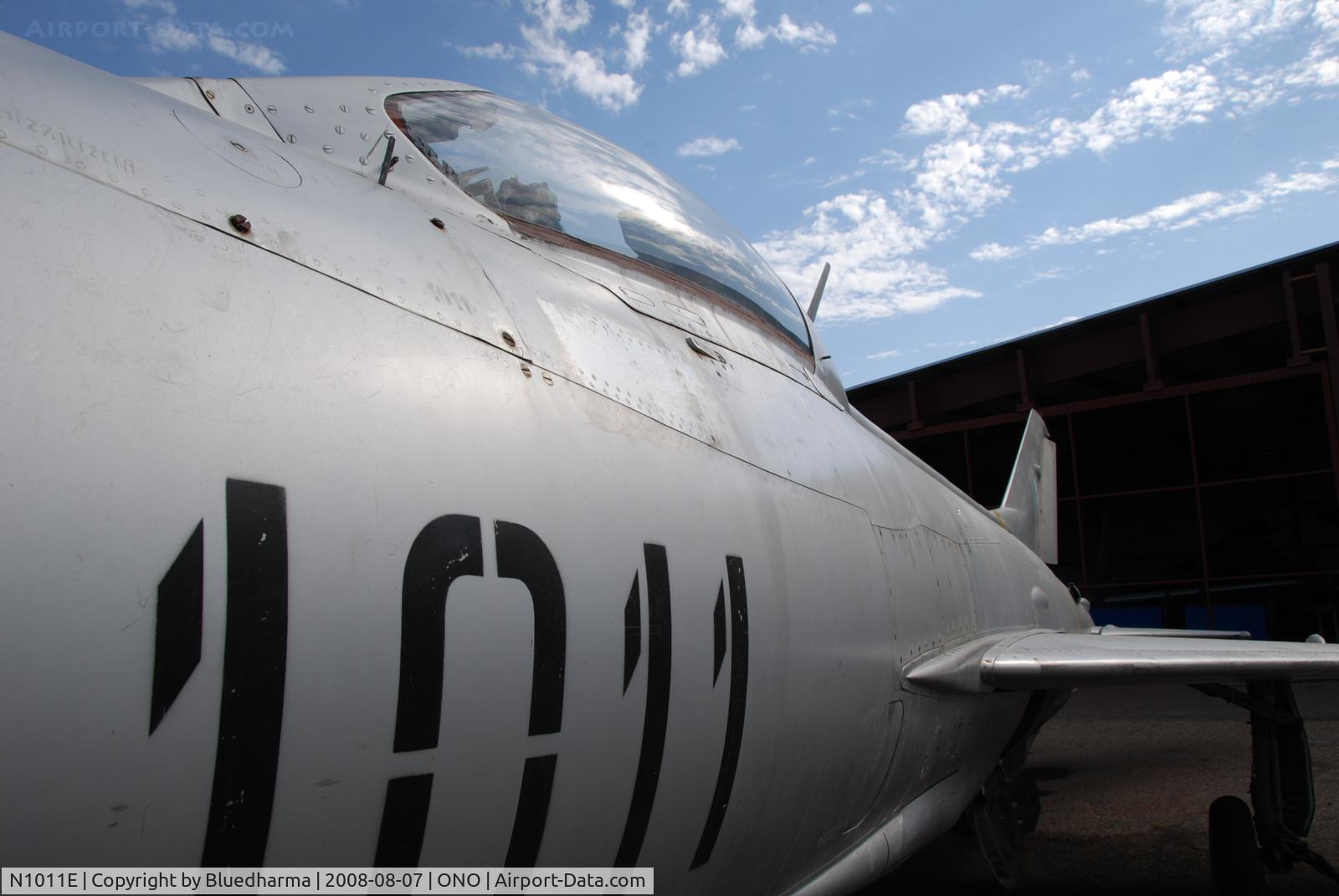 N1011E, Mikoyan-Gurevich MiG-21F-13 C/N 1011, Parked by hanger at airport.