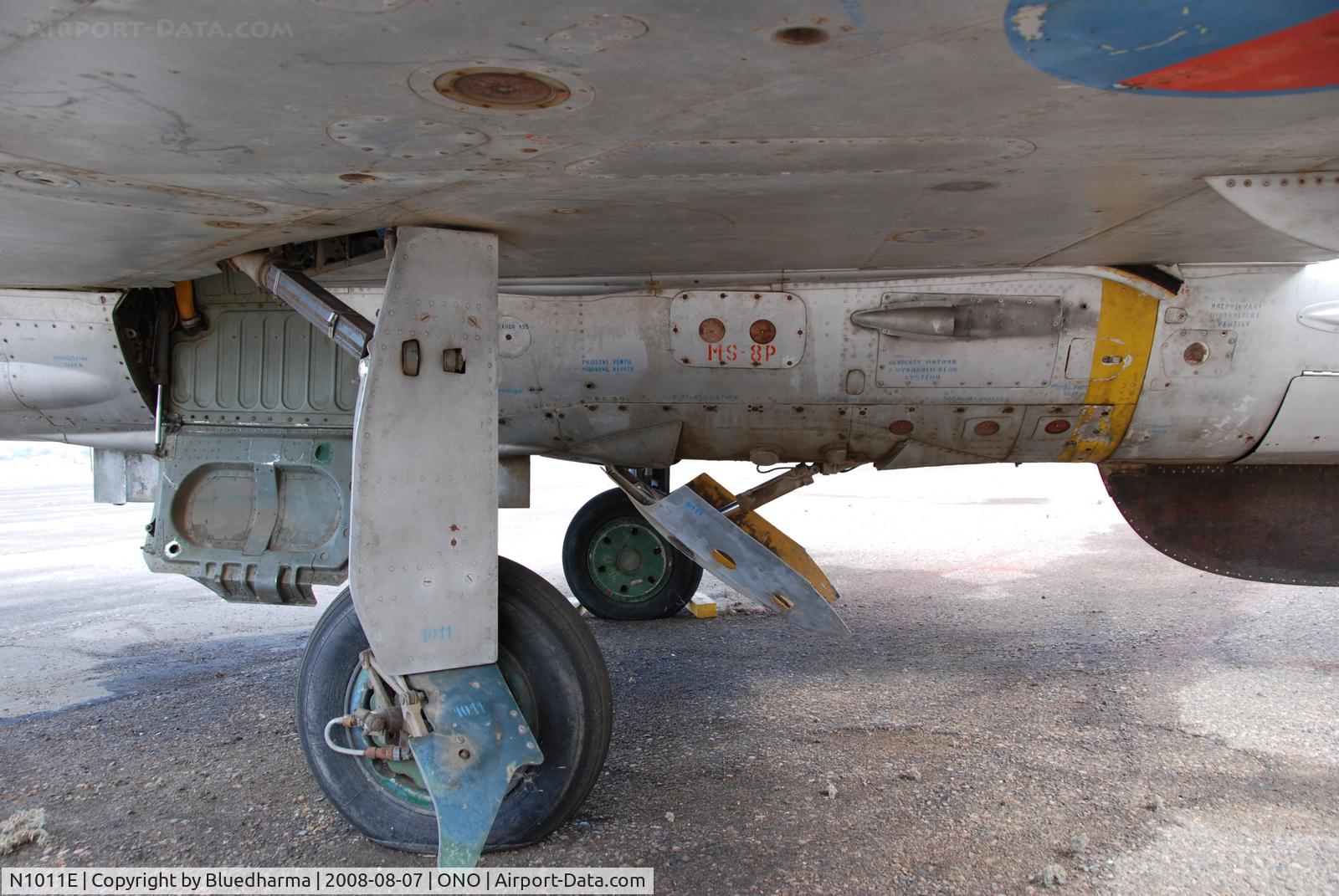 N1011E, Mikoyan-Gurevich MiG-21F-13 C/N 1011, Parked by hanger at airport.