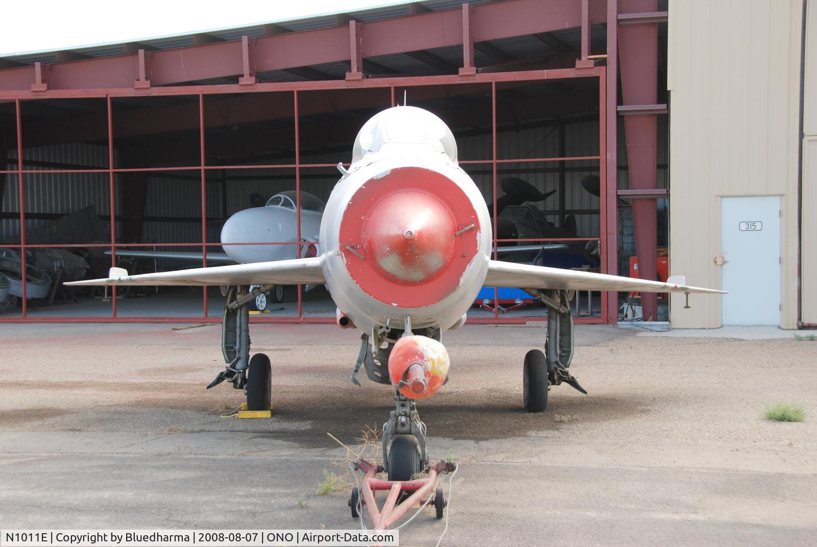 N1011E, Mikoyan-Gurevich MiG-21F-13 C/N 1011, Parked by hanger at airport.