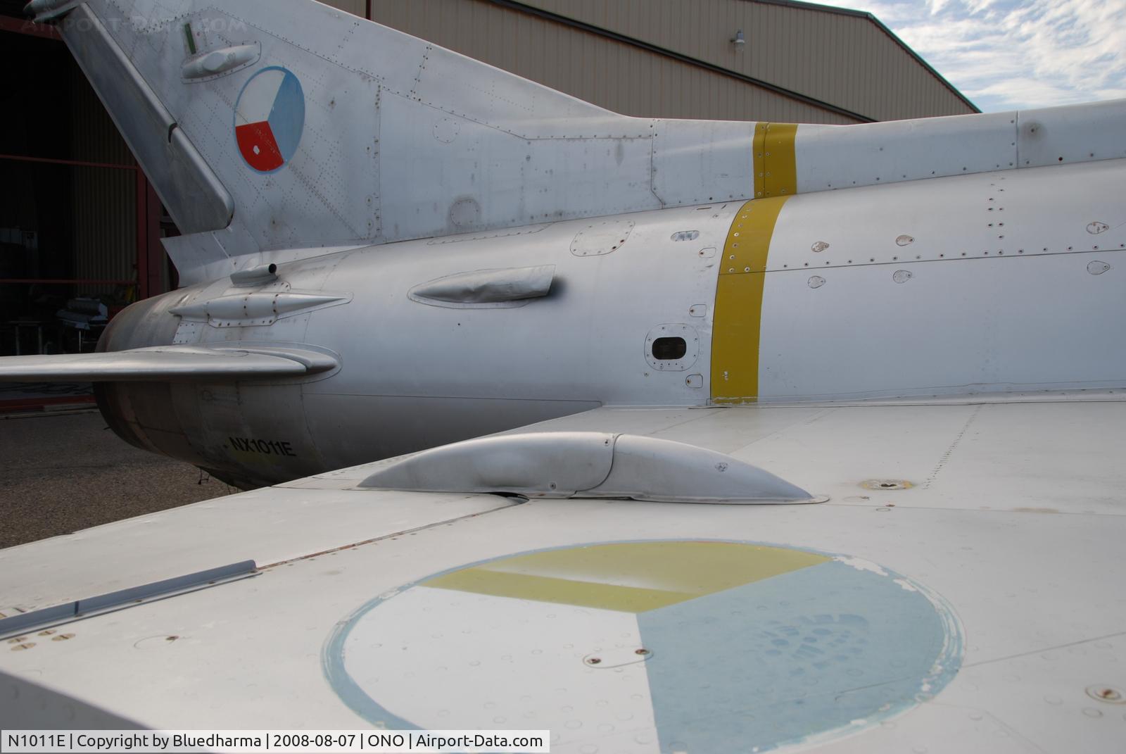 N1011E, Mikoyan-Gurevich MiG-21F-13 C/N 1011, Parked by hanger at airport.