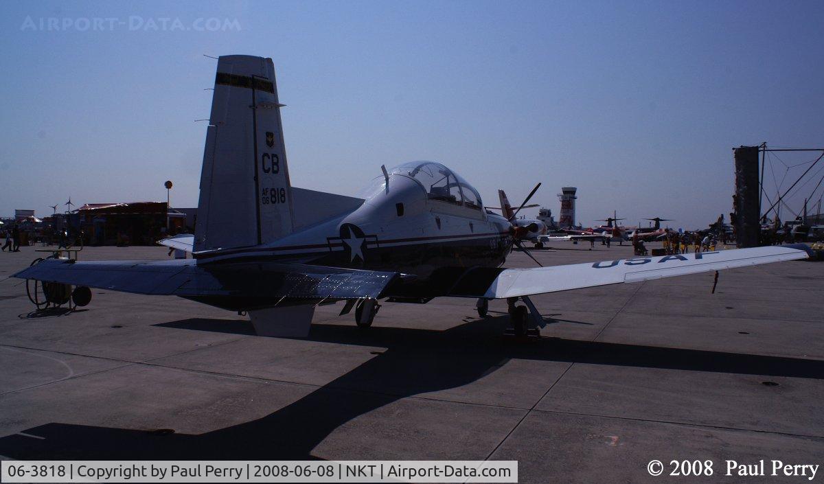 06-3818, 2006 Raytheon T-6A Texan II C/N PT-373, Slipping past her six, with the sun glaring