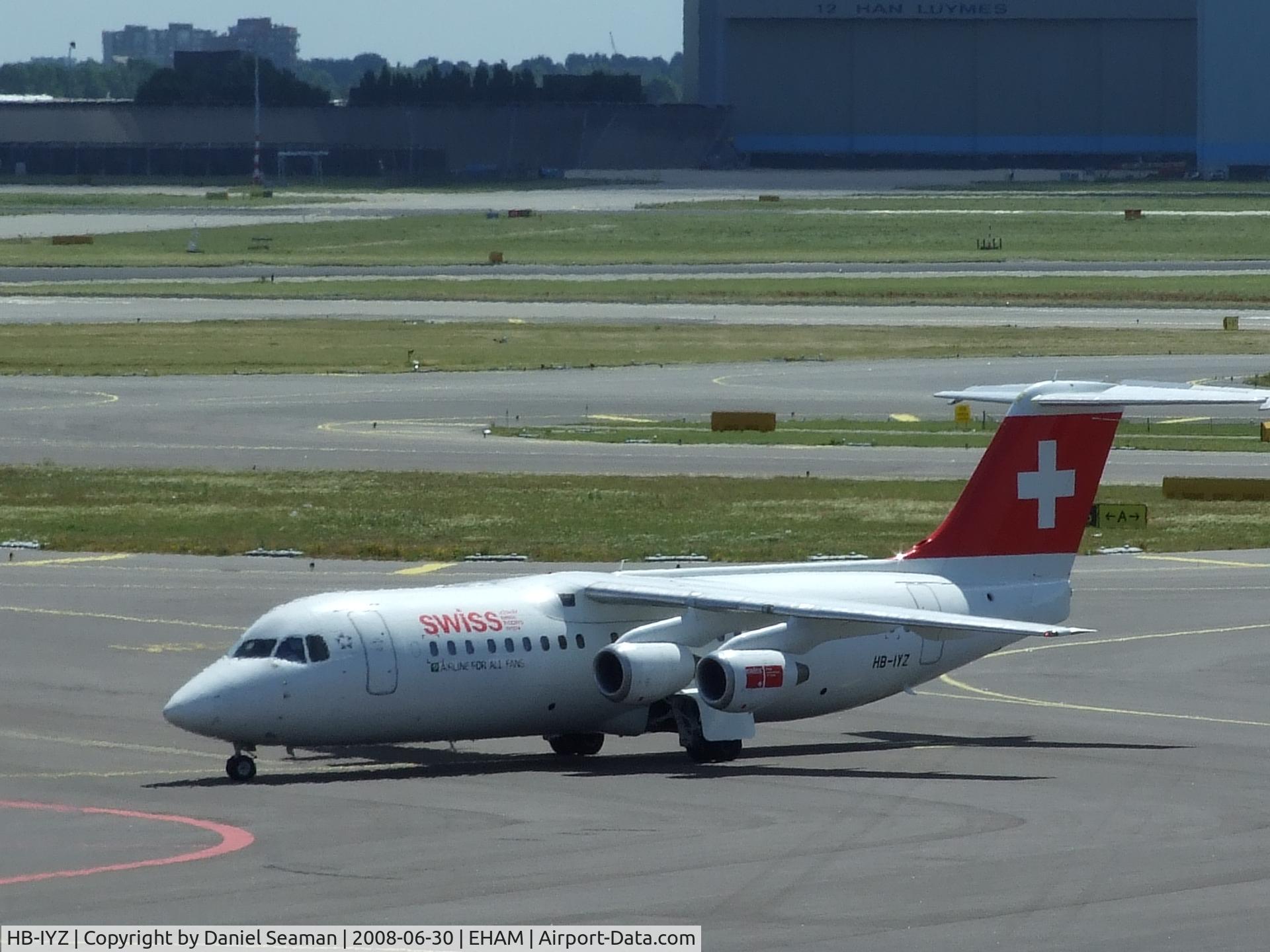 HB-IYZ, 1998 British Aerospace Avro 146-RJ100 C/N 0338, taxing onto stand.