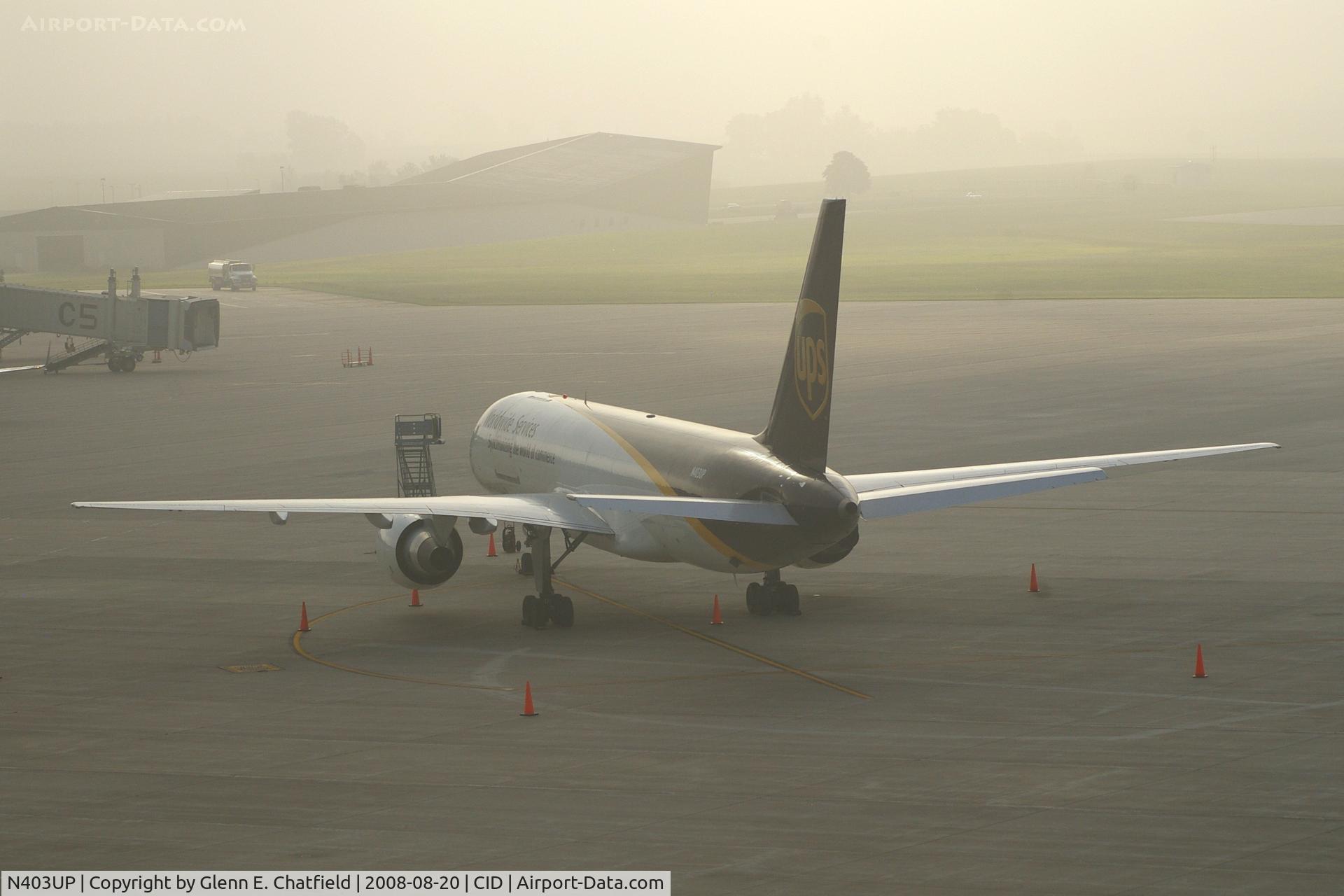 N403UP, 1987 Boeing 757-24APF C/N 23725, Early morning fog on the UPS ramp.  Fog is clearing