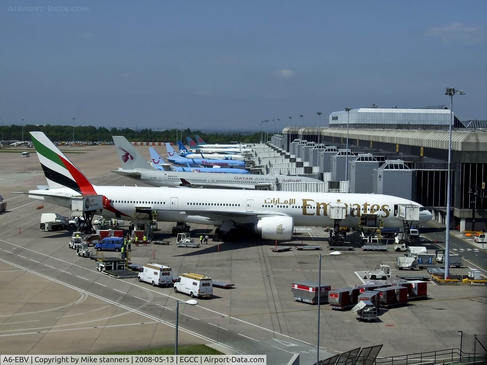A6-EBV, 2006 Boeing 777-31H/ER C/N 32728, Emirates B777 surrounded by equipment at Manchester