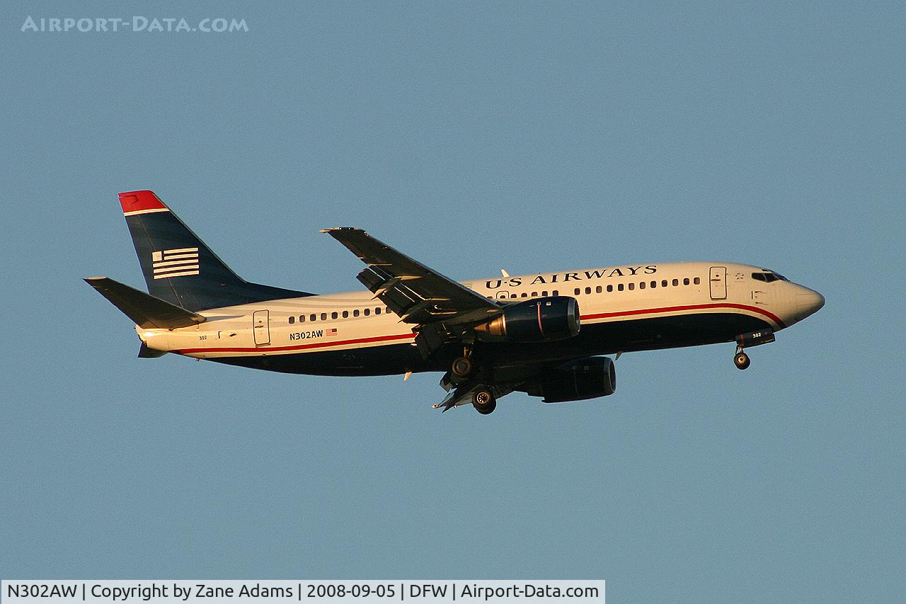 N302AW, 1988 Boeing 737-3G7 C/N 24009, Landing 13R at DFW - taken from Southlake Carrol High School football stadium during the Friday night game.