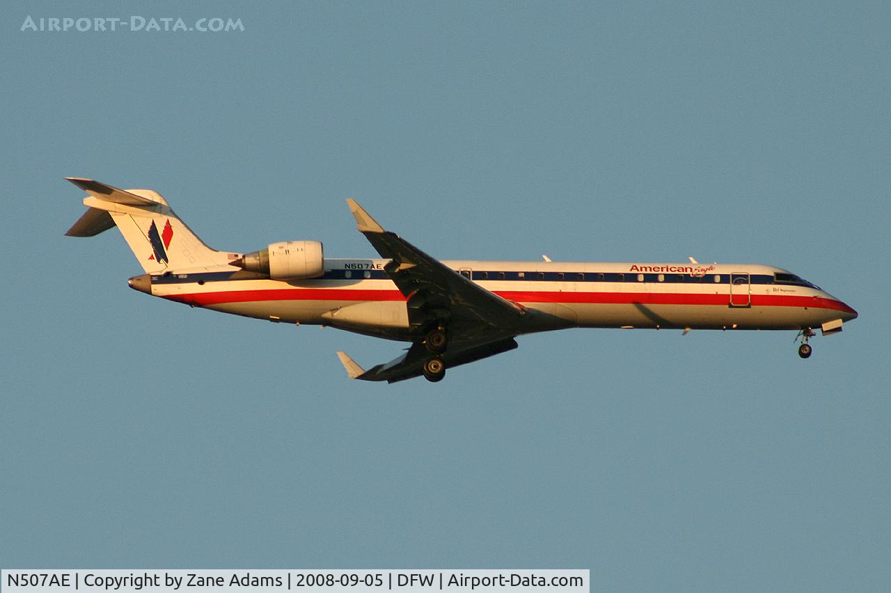 N507AE, 2002 Bombardier CRJ-701 (CL-600-2C10) Regional Jet C/N 10059, Landing 13R at DFW - taken from Southlake Carrol High School football stadium during the Friday night game.