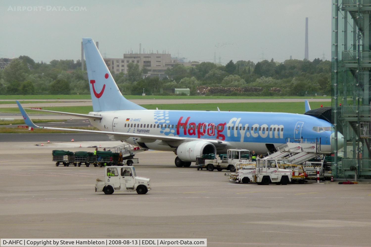 D-AHFC, 1998 Boeing 737-8K5 C/N 27977, Striking colour schemme on the Hapagfly 737 amongst the clutter at Dusseldorf