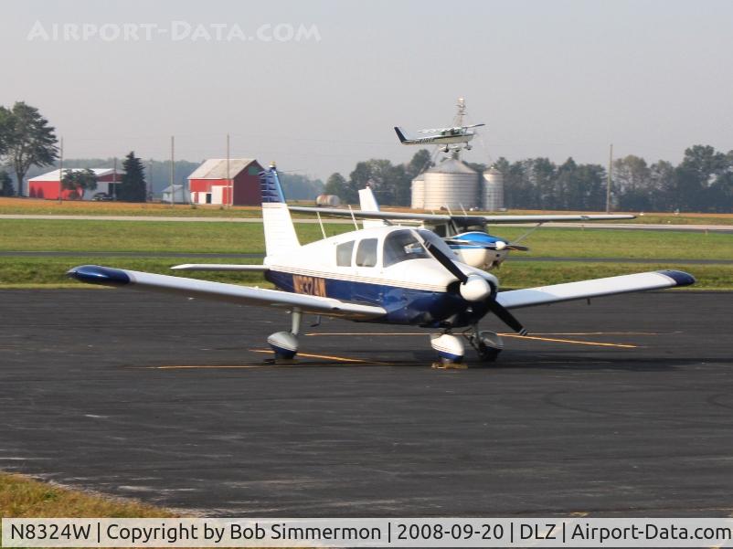 N8324W, 1965 Piper PA-28-180 C/N 28-2501, On the ramp at Delaware, Ohio.  N7830T in the background and N6968S deprating.