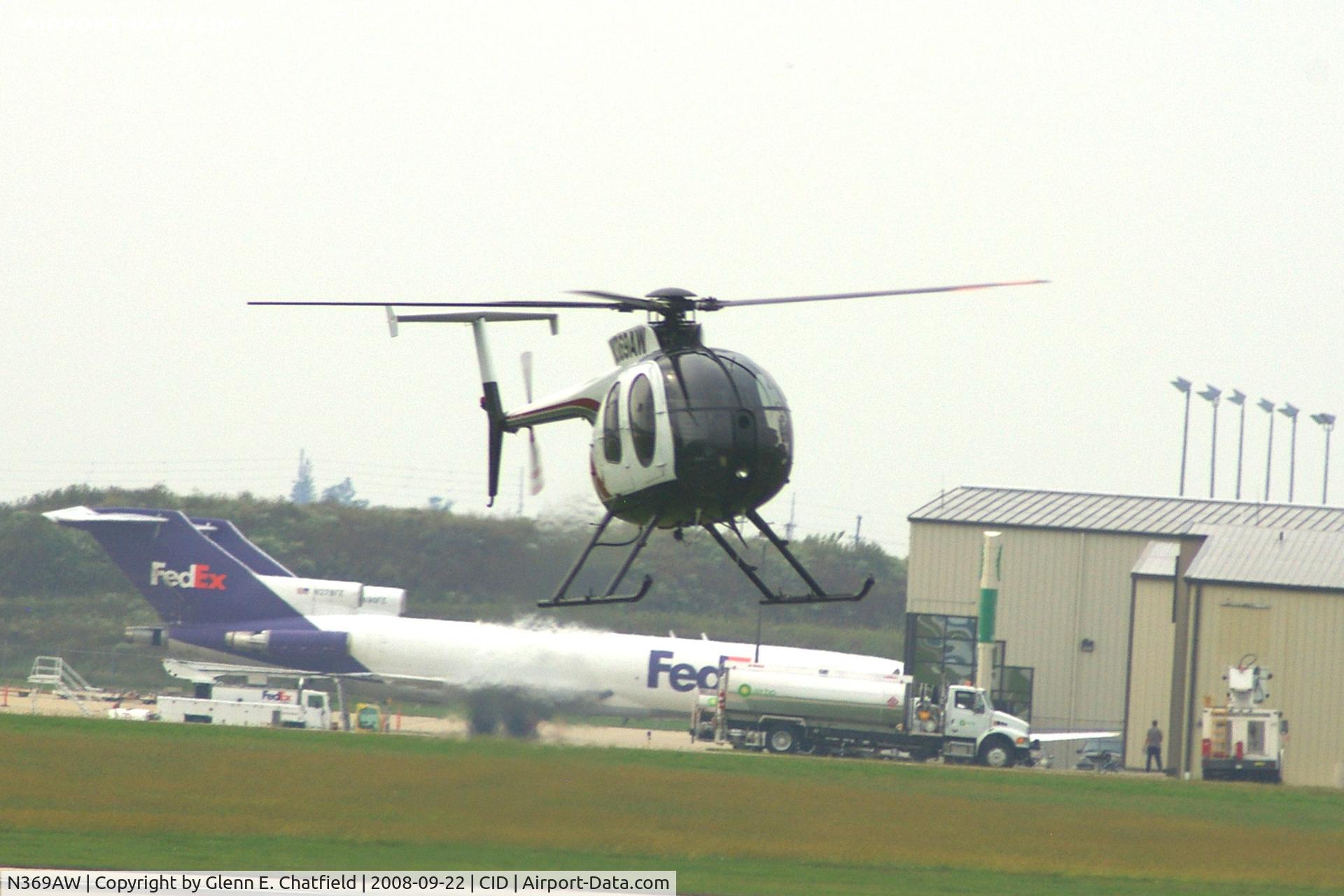 N369AW, 1977 Hughes 369D C/N 470117D, Approaching to land at the Landmark ramp.  Seen from my office window