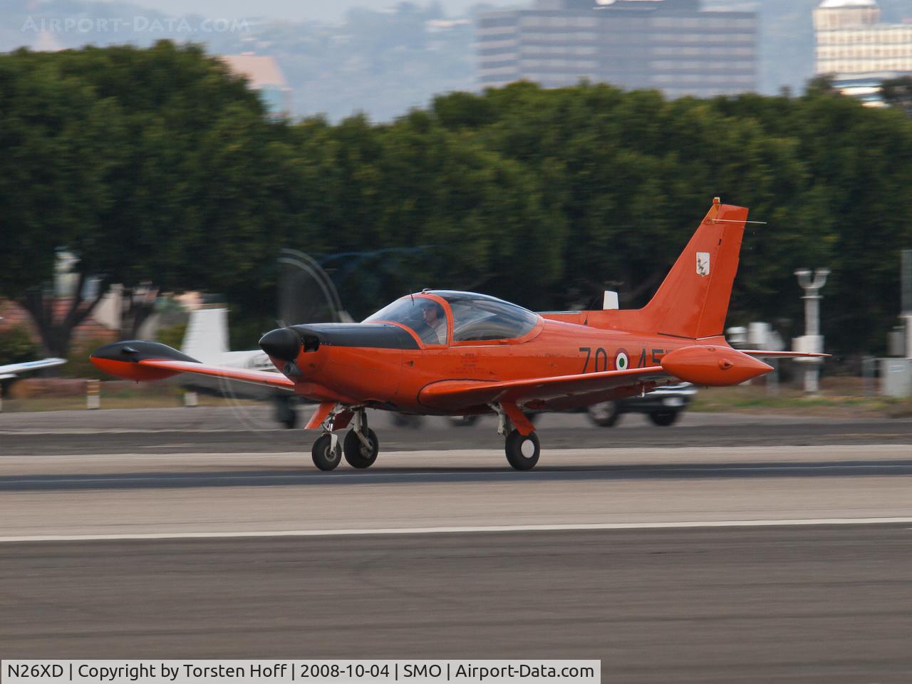 N26XD, 1987 SIAI-Marchetti F-260C C/N 40-016, N26XD departing on RWY 21. Note faint vapor compression vortices forming on propeller tips.