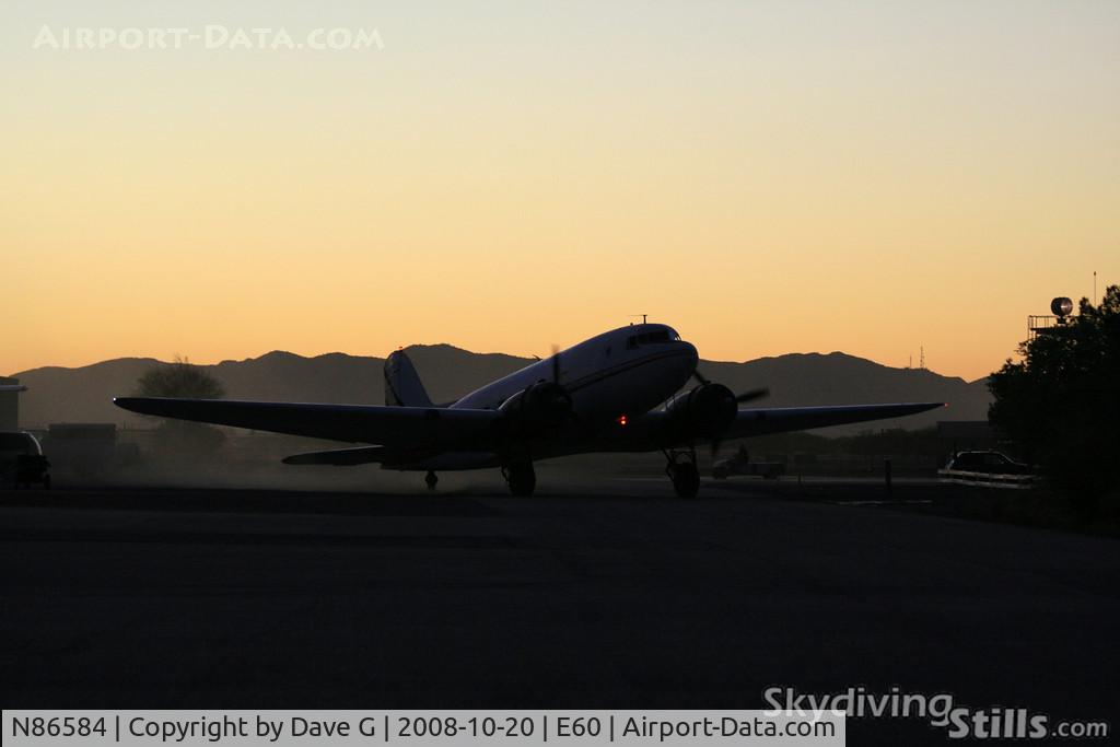 N86584, 1942 Douglas DC-3-G202A C/N 4935, DC-3 taxies in at sunset.