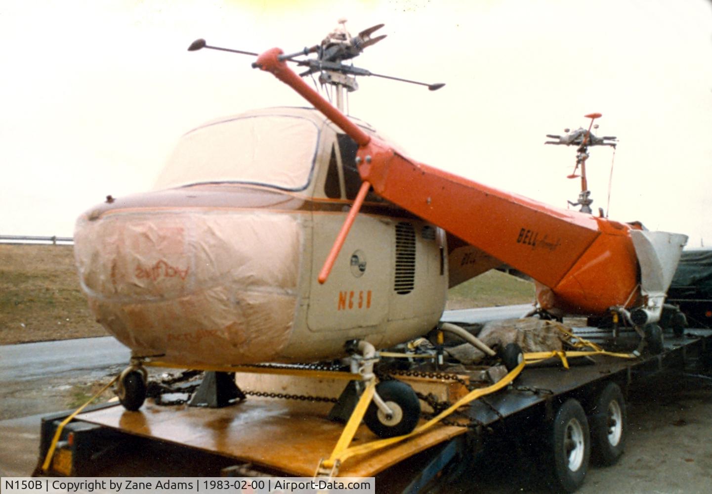N150B, 2002 Robinson R44 C/N 1199, Bell 47B-3 (the red one) On at truck in Texas being transported to a museum.