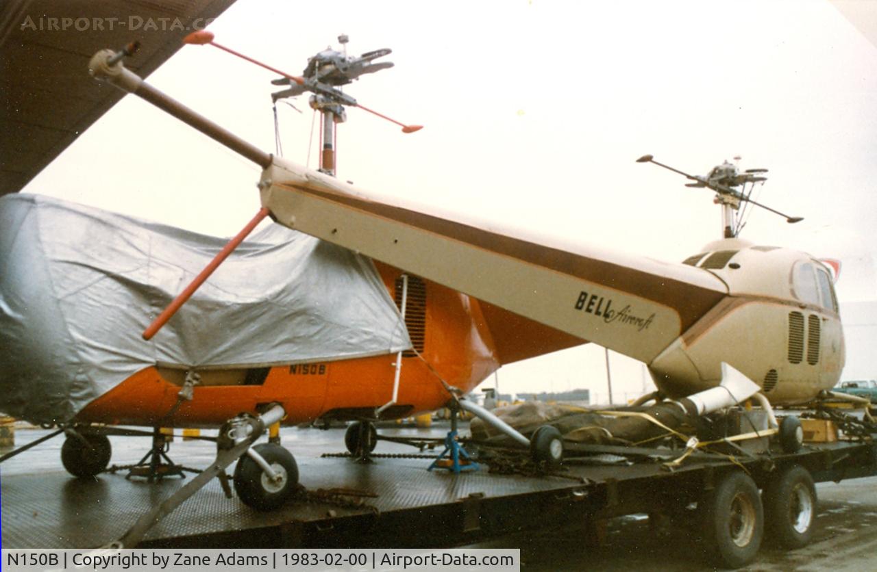 N150B, 2002 Robinson R44 C/N 1199, Bell 47B-3 (the red one) On at truck in Texas being transported to a museum.