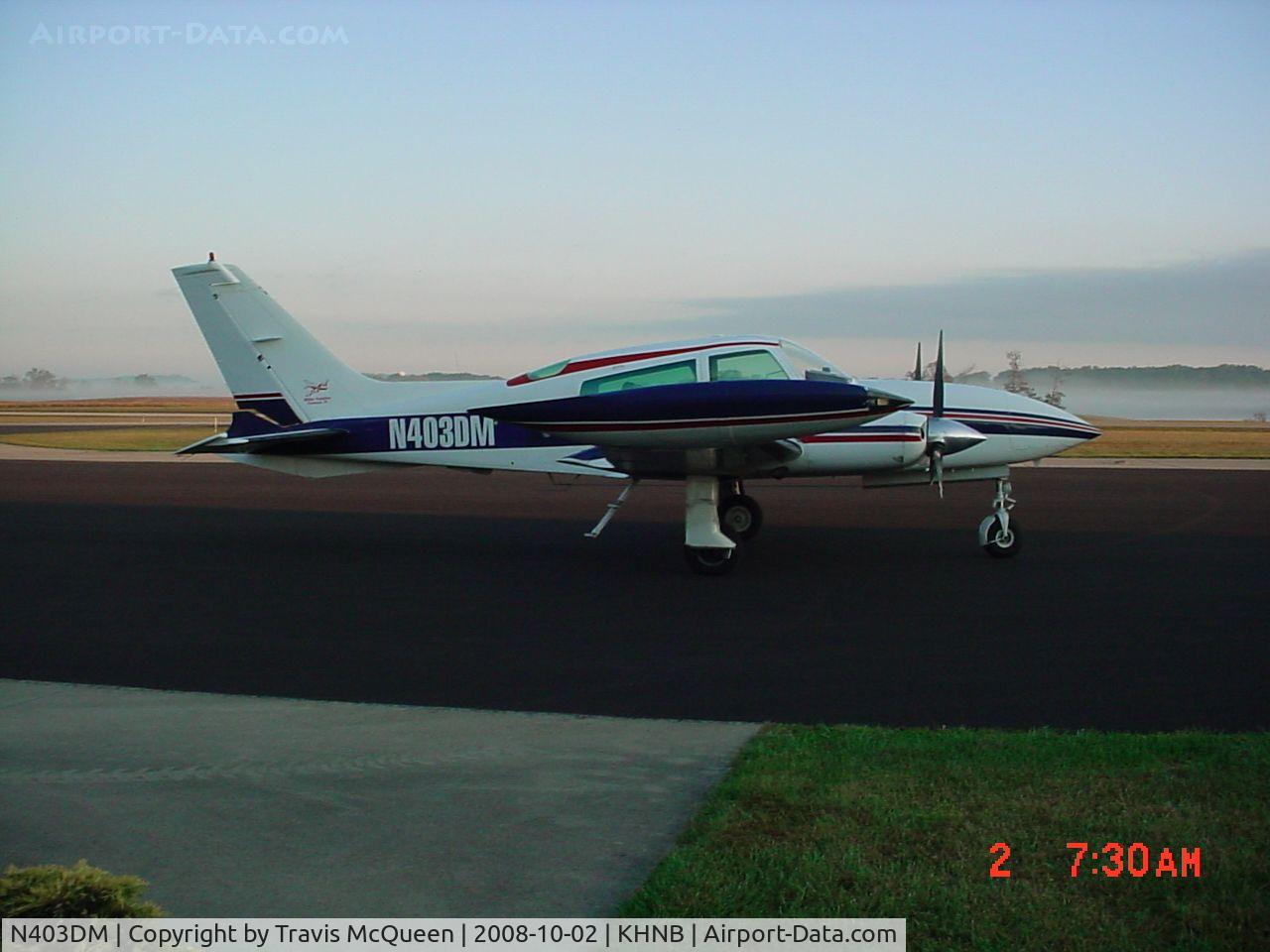 N403DM, 1975 Cessna 310R C/N 310R0146, Parked on ramp in front of Terminal... with fog in the background...