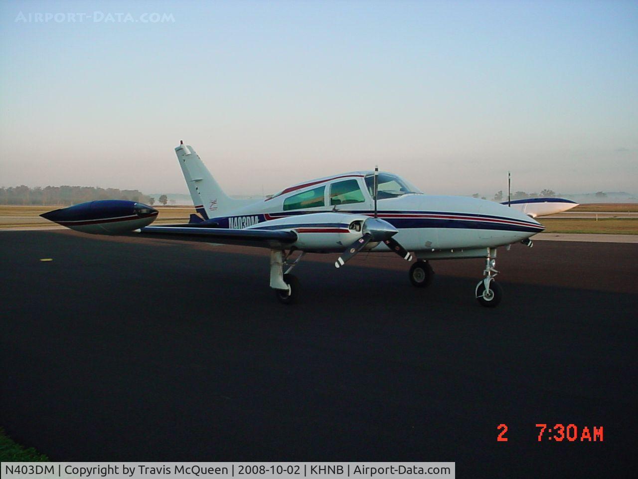 N403DM, 1975 Cessna 310R C/N 310R0146, Parked on ramp in front of Terminal... with fog in the background... Angle shot...