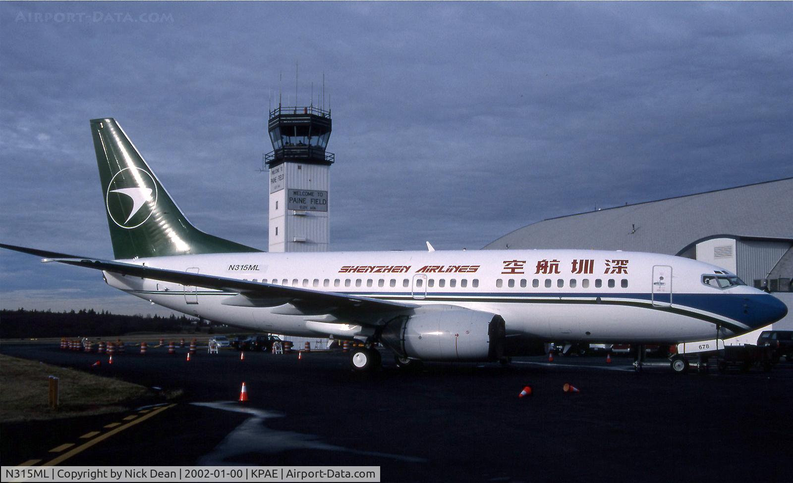 N315ML, 2001 Boeing 737-76N C/N 32244, Repainted in the Schenzen scheme but still carrying the Midway reg. and our nice old tower in the background.