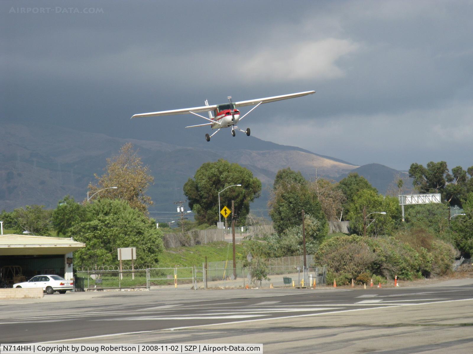 N714HH, 1977 Cessna 150M C/N 15079185, 1977 Cessna 150M, Continental O-200 100 Hp, really big slip angle vis-a-vis Rwy 22. Note: No stall/spin, pretty good crosswind landing from this slip. I found myself in harm's way between the runway and the aircraft heading for this shot!