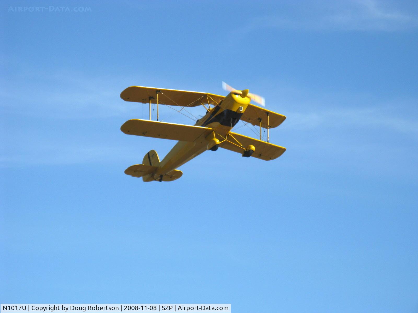 N1017U, 1939 CASA 1-131 Jungmann C/N E3B-435, 1939 Bucker Jungmann C.A.S.A. 1.131, Lycoming O-360 180 Hp upgrade, fully aerobatic, takeoff climbout over Rwy 22