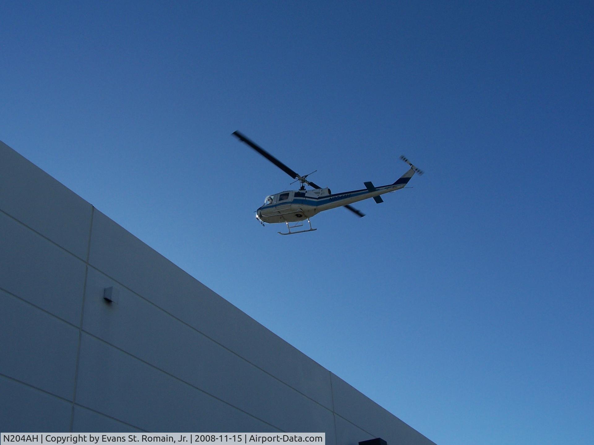 N204AH, 1985 Bell 204B C/N 2030, Placing A/C units on a roof