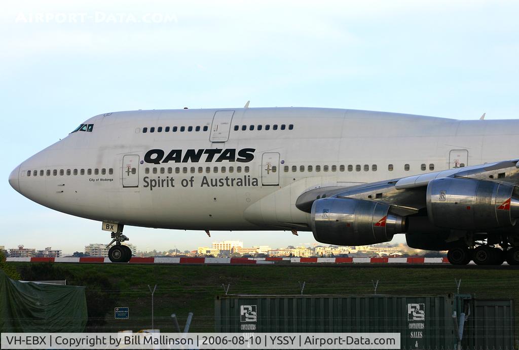 VH-EBX, 1986 Boeing 747-338 C/N 23688, 0640 hrs with the sun coming up...on parts of Brighton le Sands in the background