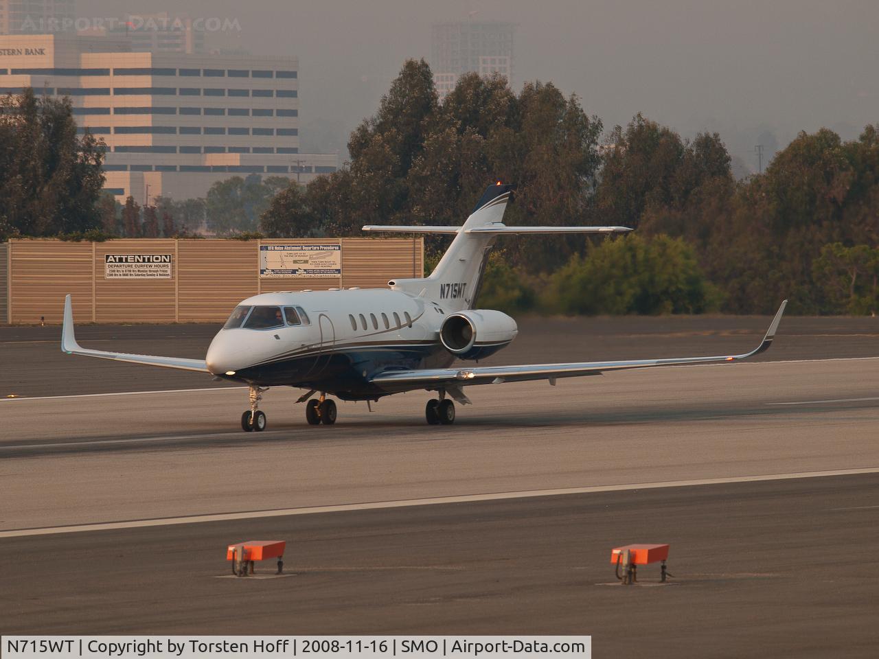 N715WT, 1998 Raytheon Hawker 800XP C/N 258386, N715WT departing from RWY 21 into a sky full of smoke from wildfires.