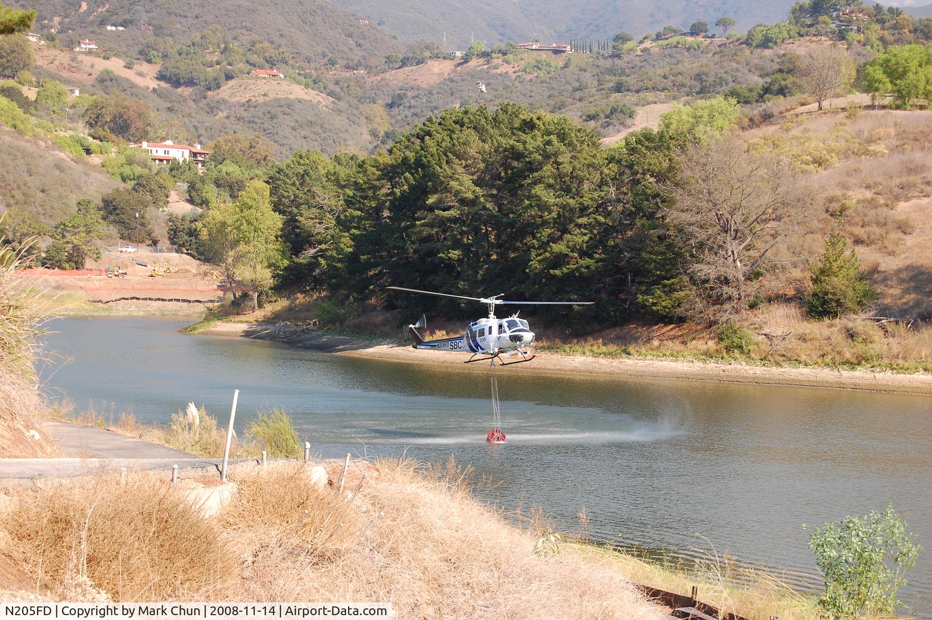 N205FD, Bell UH-1H Iroquois C/N 5305, Filling water bucket at Lauro Reservoir, Santa Barbara, CA. while fighting Tea Fire.