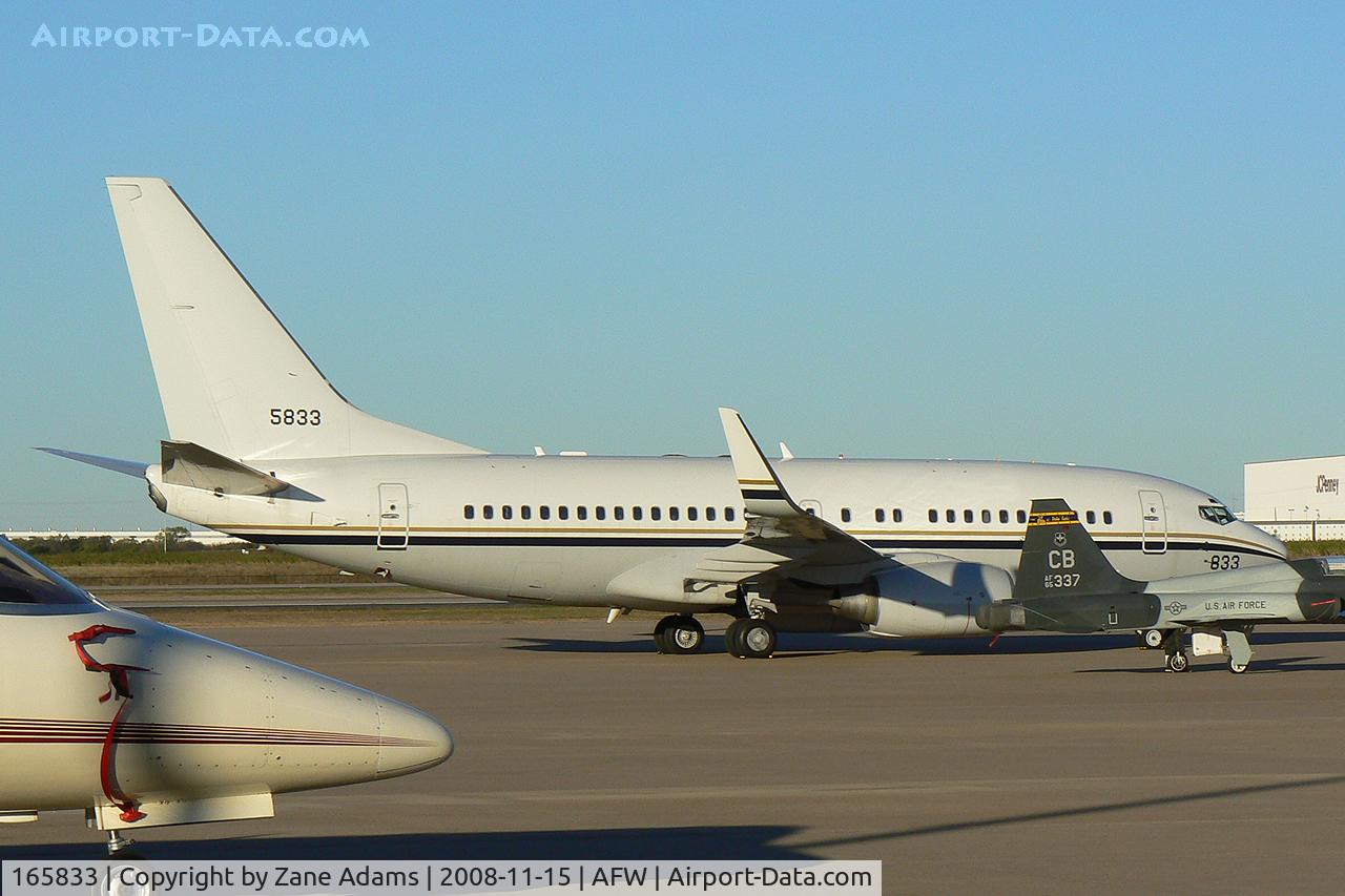 165833, 2002 Boeing C-40A (737-7AF) Clipper C/N 32597, At Alliance - Fort Worth - Parked in a ramp full of stuff! - US Navy C-40A Clipper