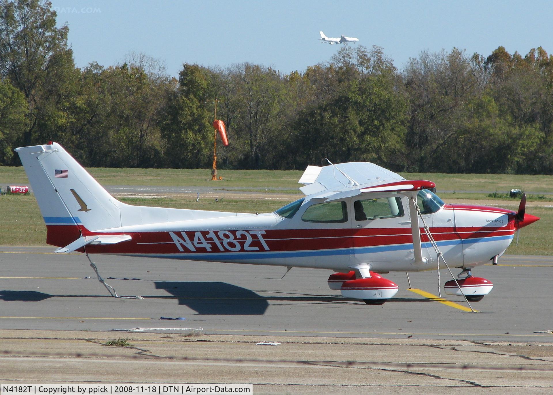 N4182T, 1978 Cessna 172N C/N 17270319, Parked at Downtown Shreveport with a E-8 JSTARS (B707) coming in to Barksdale Air Force Base in the background.